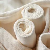 Closeup of organic cotton fabric rolls